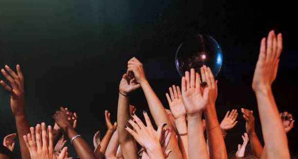 large crowd with hands up in nightclub - concert stock pictures, royalty-free photos & images