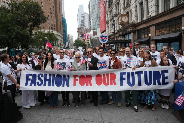 Led by US fashion designer Tory Burch and US fashion designer Michael Kors , attendees march in the "Fashion For Our Future" rally to raise awareness...