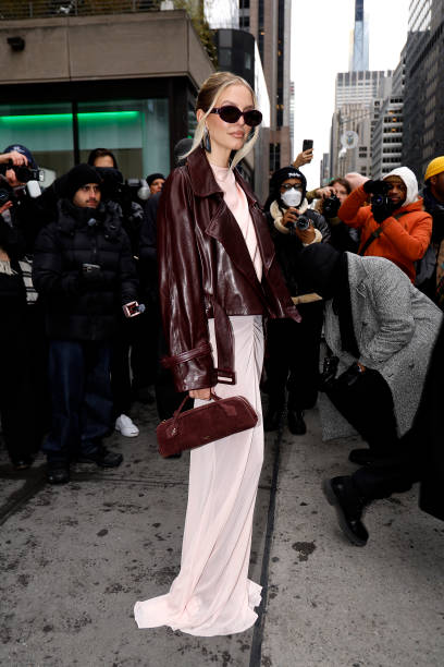 Leonie Hanne wearing a leather jacked long pink dress and bag arrives at the LaPointe show during New York Fashion Week on February 09, 2025 in New...