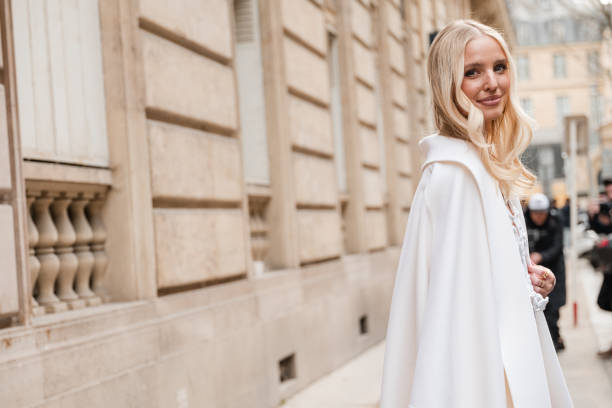 Leonie Hanne wears cream coat, outside Valentino, during the Womenswear Fall/Winter 2024/2025 as part of Paris Fashion Week on March 03, 2024 in...
