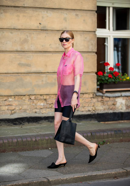 Lisa Banholzer is seen wearing pink sheer button shirt Miu Miu, slipper Miu Miu, bag vintage, cycle pants, sunglasses during Mercedes Benz Fashion...