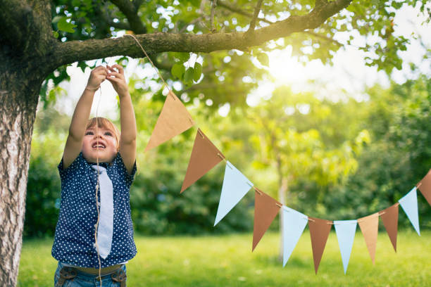 little child preparing a party event - garden decoration stock pictures, royalty-free photos & images