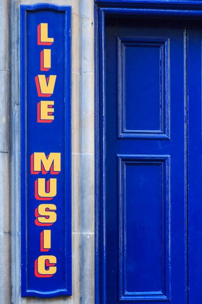 live music sign painted in yellow on the blue exterior wall of a pub. edinburgh. scotland. - concert stock pictures, royalty-free photos & images