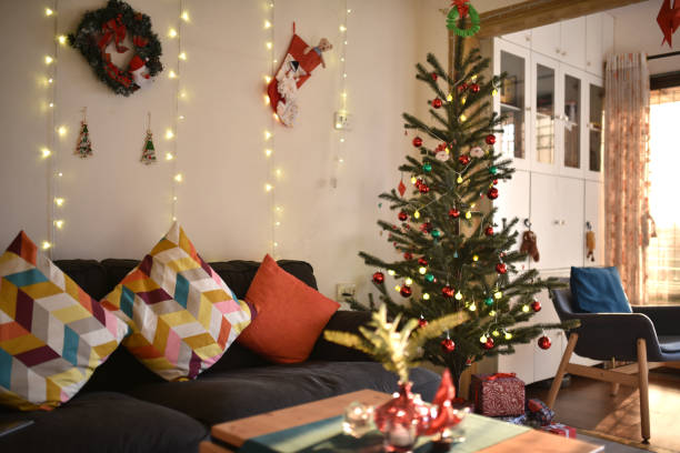 living room decorated for christmas with christmas tree and string lights - home decoration stock pictures, royalty-free photos & images