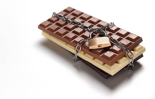 lock up your chocolate dieting forbidden addiction - junk food stockfoto's en -beelden