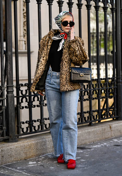 Loli Olivera is seen wearing an animal print jacket, black sweater, blue jeans, head scarf, black sunglasses and black bag outside the Bevza show...
