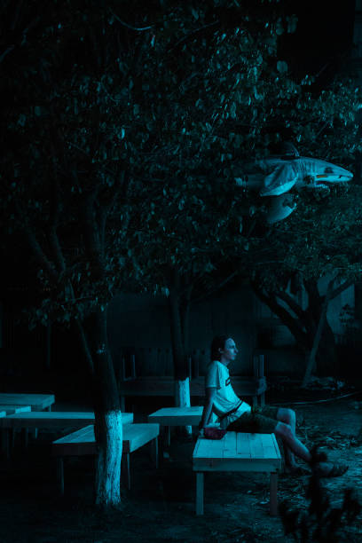 lonely man in the empty night garden - garden decoration stock pictures, royalty-free photos & images