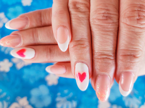 long fingernails in pink color and heart shape - nails art stock pictures, royalty-free photos & images