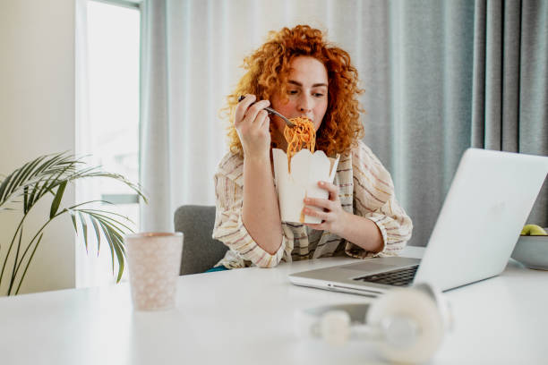 lunch break when working from home is time to think - junk food stock pictures, royalty-free photos & images