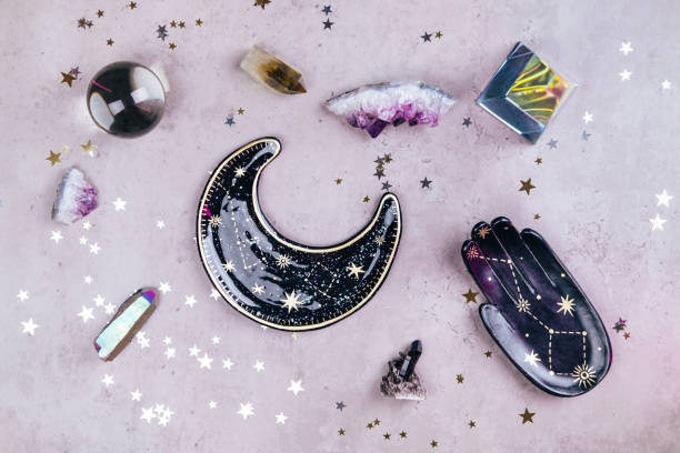 magic crystals for rituals. esoteric set with many tools on concrete gray background with silver and gold stars sequins. flat lay style - home decoration stockfoto's en -beelden