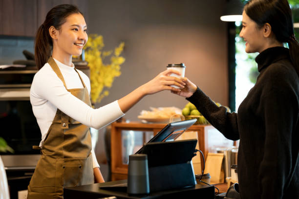 make me happy with drinks coffee. young asian women coffee shop owner serving black coffee to her customers in a cafe. service mind, point of sale system, and take-out foods. - junk food stock pictures, royalty-free photos &