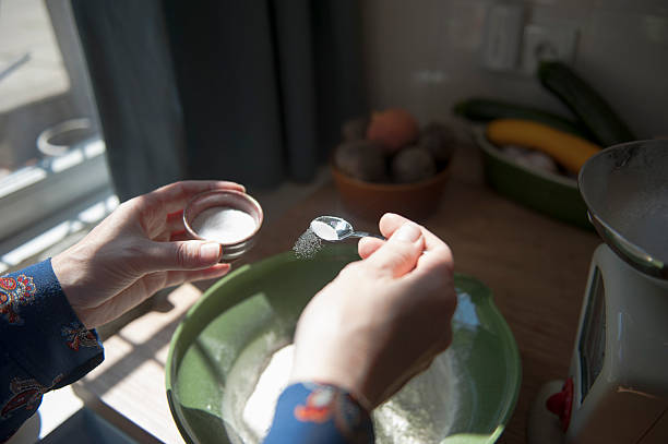 making bread, adding salt - food photos et images de collection