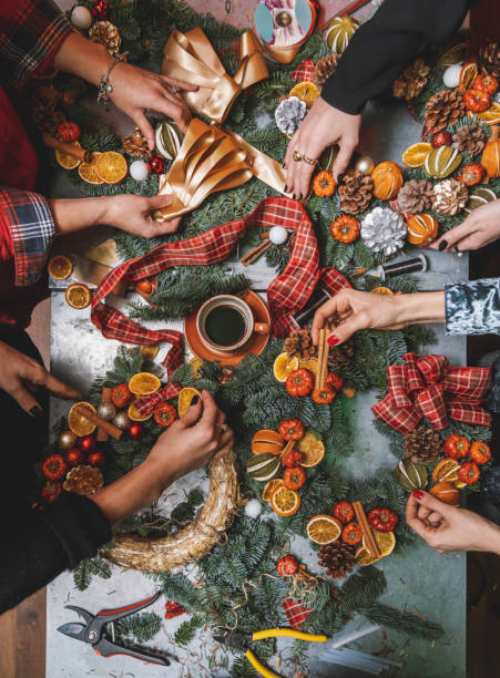 making christmas door wreath with equipments in decorator's workplace - home decoration stock pictures, royalty-free photos & images