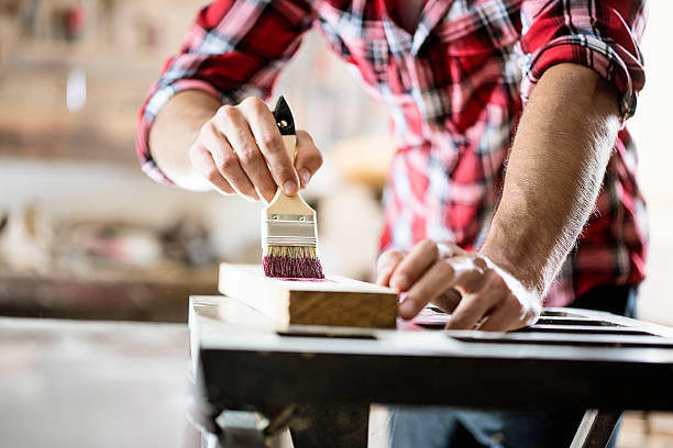 male carpenter varnishing board close up - home decoration stock pictures, royalty-free photos & images