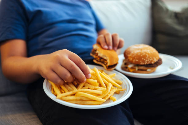 male hands eating french fries - junk food stock pictures, royalty-free photos & images