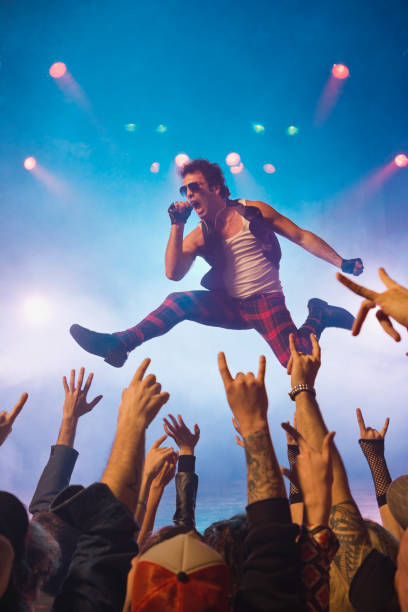 male rock star performing in front of audience - concert stock pictures, royalty-free photos & images