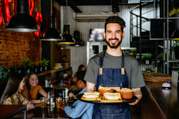 male waiter with tray of snacks at buenos aires restaurant - food stock pictures, royalty-free photos & images