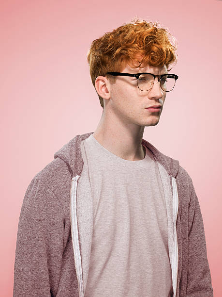 male with curly red hair and glasses looking away - fashion stock pictures, royalty-free photos & images
