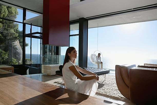 man and woman sitting far apart - home decoration stock pictures, royalty-free photos & images