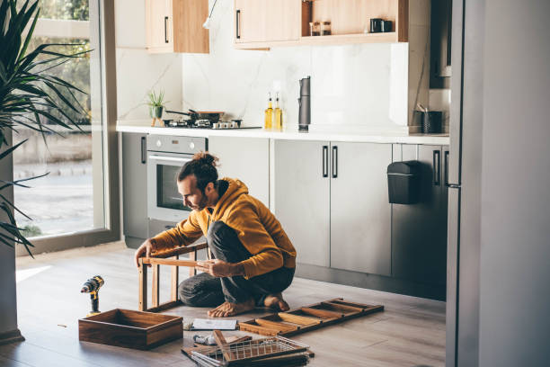 man assembling furniture at home. - home decoration stock pictures, royalty-free photos & images