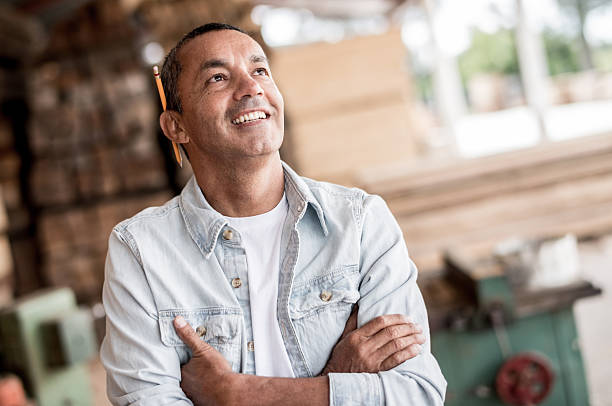man at a carpentry looking thoughtful - home decoration stock pictures, royalty-free photos & images
