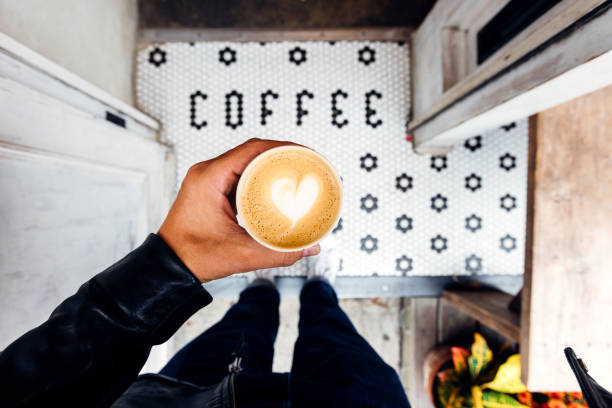man buying takeaway coffee in a coffee shop, personal perspective view - junk food stock pictures, royalty-free photos & images