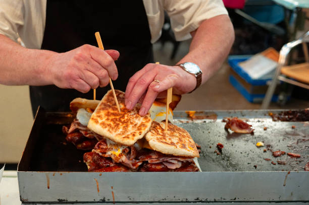 man cooking sandwiches - junk food stock pictures, royalty-free photos & images