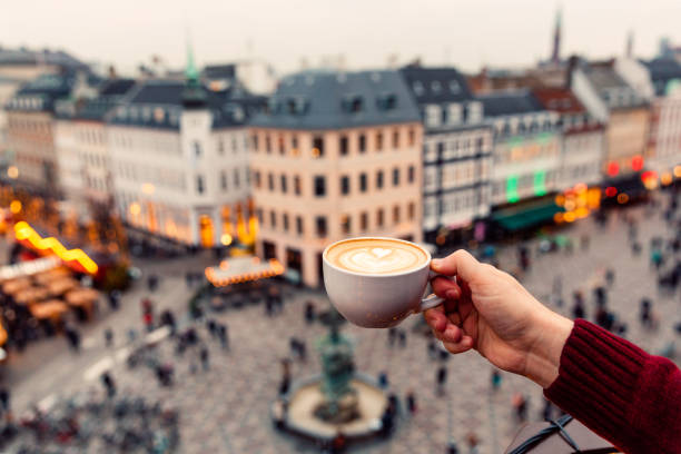 man drinking coffee with a view of copenhagen skyline, denmark - travel stock-fotos und bilder