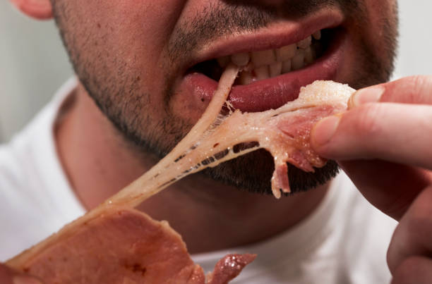 man eating bacon - junk food stock pictures, royalty-free photos & images