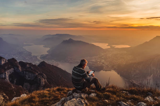 man hiker solo on the mountain during golden hour - travel stock pictures, royalty-free photos & images