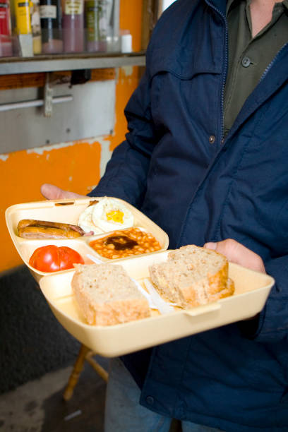 Man holding a takeaway all day breakfast in a polystyrene container on the 21st June 2008 in Victoria in the United Kingdom.