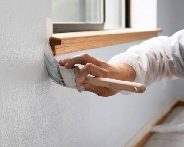 man painting interior of home by window - home decoration stock pictures, royalty-free photos & images