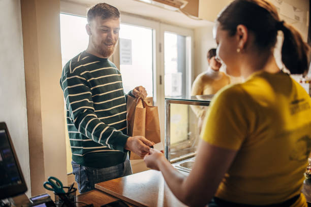 man paying for lunch - junk food stock pictures, royalty-free photos & images