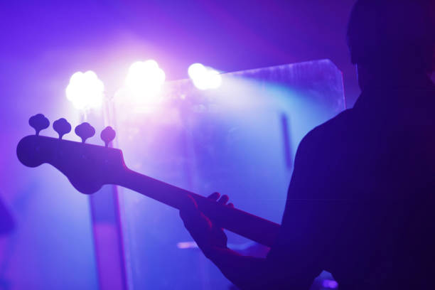 man playing guitar on stage - concert stock pictures, royalty-free photos & images
