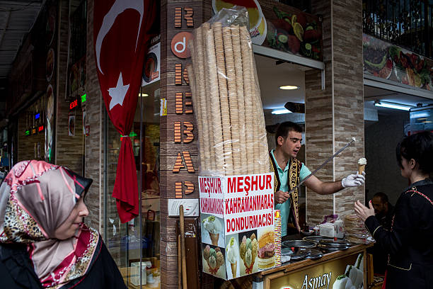 Man sells Turkish ice cream to a customer on a market street in Eminonu on September 26, 2016 in Istanbul, Turkey. Credit rating agency Moody's...