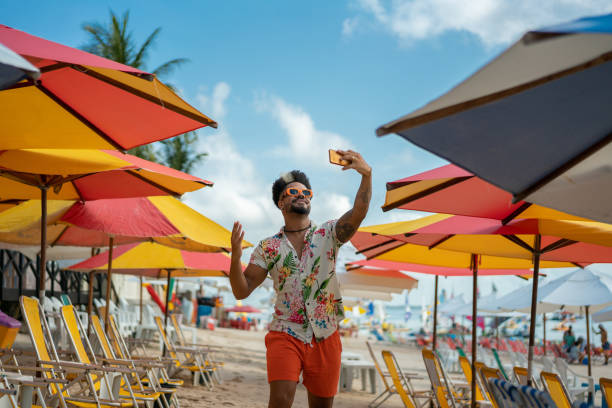 man vlogging on the beach - travel stock pictures, royalty-free photos & images