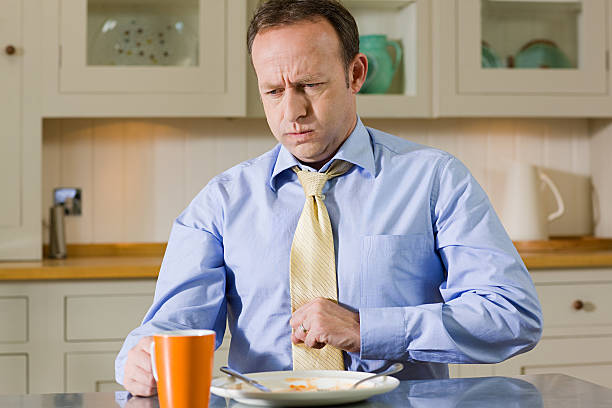 man with indigestion - junk food stock pictures, royalty-free photos & images