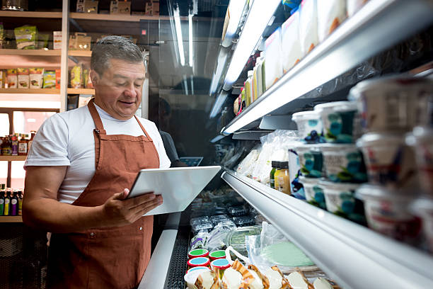 man working at a grocery store - food stock pictures, royalty-free photos & images