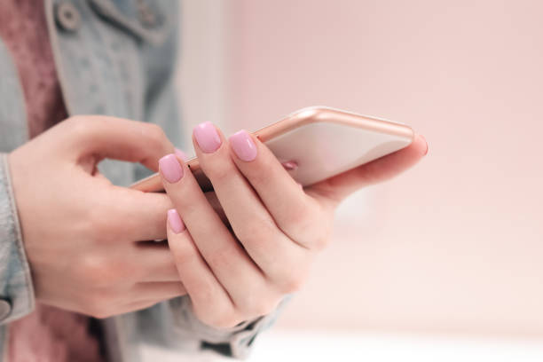 manicure - beauty treatment photo of nice manicured woman fingernails. very nice feminine nail art with nice red, white and black nail polish. processed in retro colors. selective focus. - nails art photos et images de collec