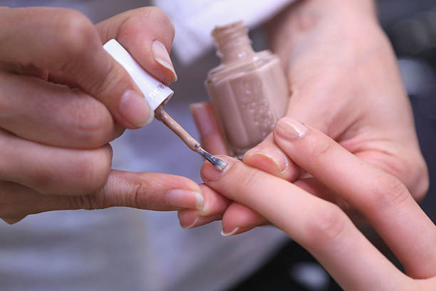 Manicurists backstage paint models' nails with essie polishes for Proenza Schouler Fall/ Winter 2016 during New York Fashion Week at the Whitney...