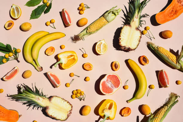 many yellow fruits and vegetables on a yellow background. - food stock pictures, royalty-free photos & images