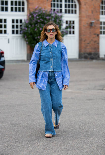 Masha Sedgwick wears striped button shirt, jeans, top outside Baum & Pferdgarten during day three of the Copenhagen Fashion Week SS25 on August 07,...