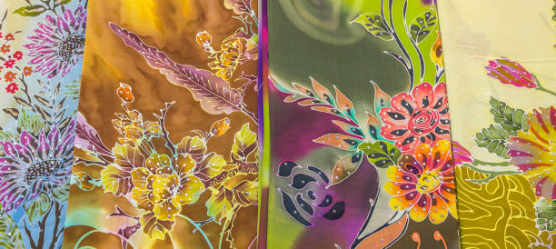 mass produced colored textile in a traditional east market in malaysia - garden decoration stock-fotos und bilder
