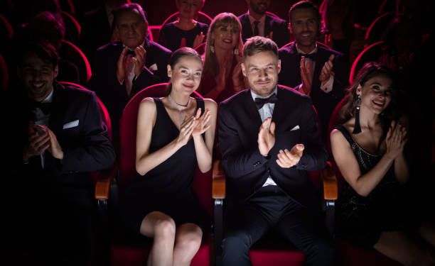 mature couple clapping while watching opera - concert stock pictures, royalty-free photos & images