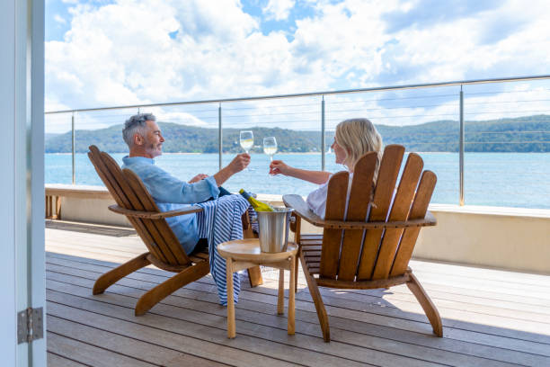 mature couple drinking wine out on the deck. - travel stock pictures, royalty-free photos & images