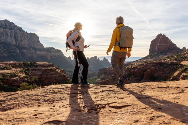 mature couple hike through desert landscape - travel stock pictures, royalty-free photos & images