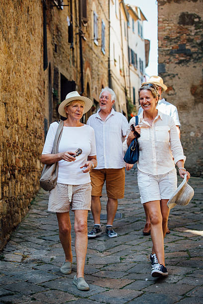 mature friends looking around old town italy - travel stock pictures, royalty-free photos & images