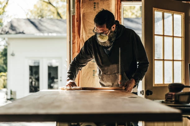 mature man working on home improvement project in garage - home decoration stock pictures, royalty-free photos & images