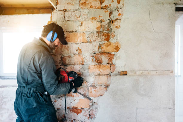 mature worker demolishing wall with drill at house - home decoration stock pictures, royalty-free photos & images