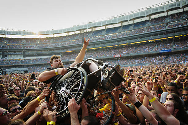 Megadeth fan in a wheelchair is hoisted for a better view during "The Big 4" -- a concert event featuring Metallica, Slayer, Megadeth and Anthrax at...